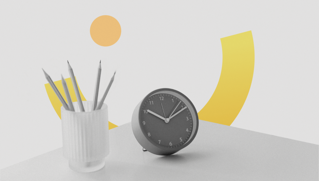 An alarm clock and pencils in a work desk that shows stress-free productivity.